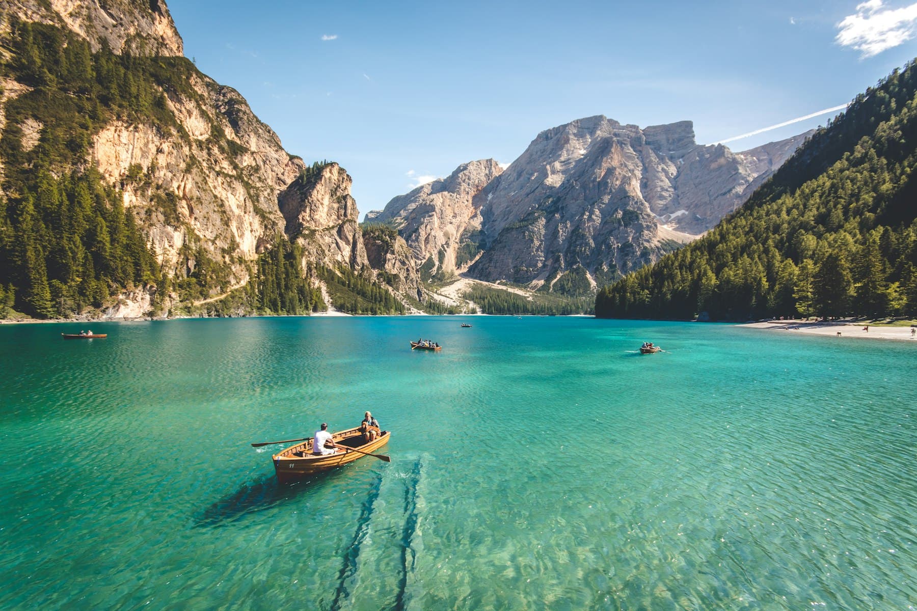 Boat on clear water beneath the peaks